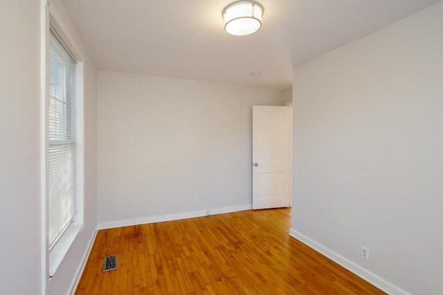 empty room with hardwood / wood-style floors