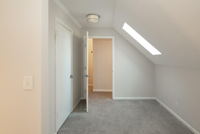 bonus room with lofted ceiling with skylight and light carpet