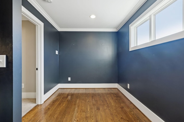 spare room with ornamental molding and hardwood / wood-style flooring