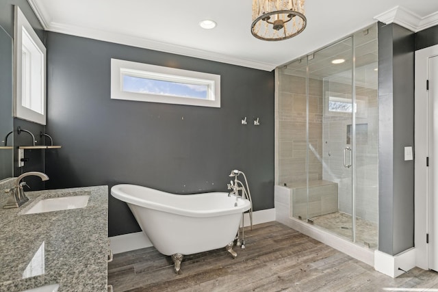 bathroom with hardwood / wood-style flooring, vanity, crown molding, and independent shower and bath