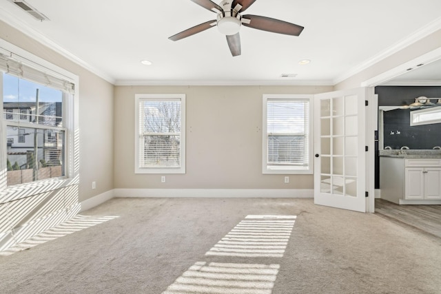 spare room with light carpet, ceiling fan, and ornamental molding