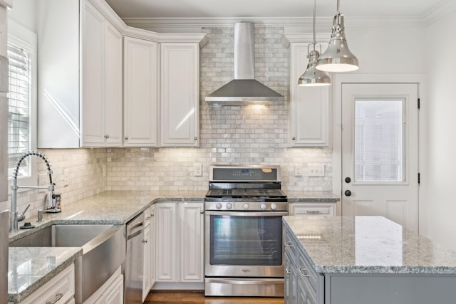 kitchen with white cabinets, light stone counters, wall chimney exhaust hood, and appliances with stainless steel finishes