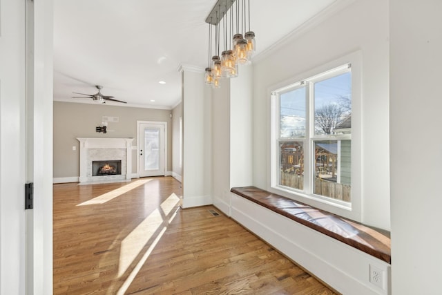 hall with light wood-type flooring and crown molding