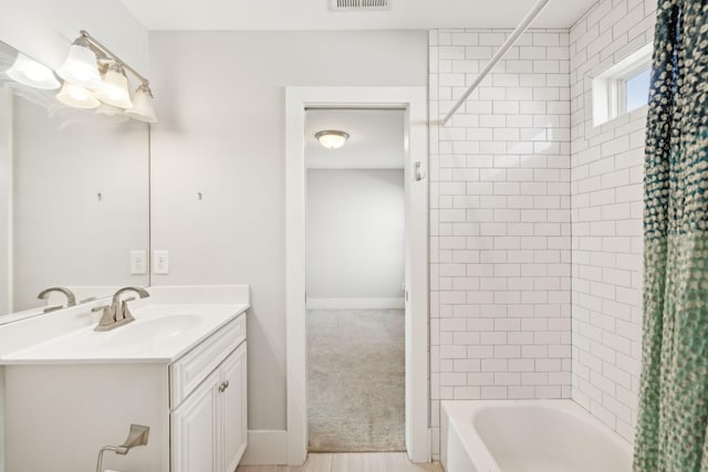 bathroom featuring vanity and shower / bath combo