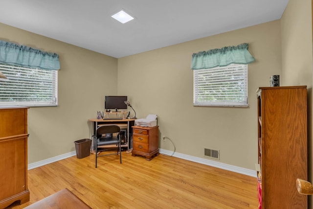 office with light hardwood / wood-style floors