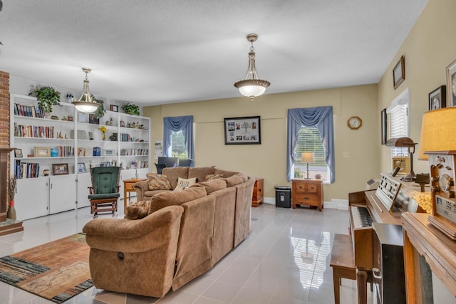 living room with a textured ceiling and light tile patterned floors