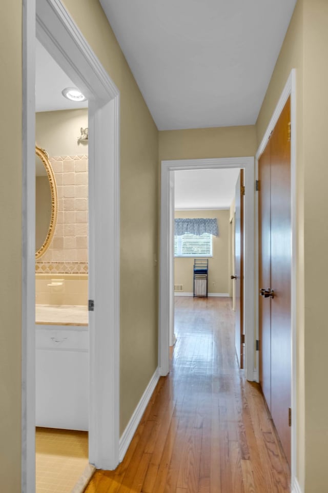 corridor with light wood-type flooring