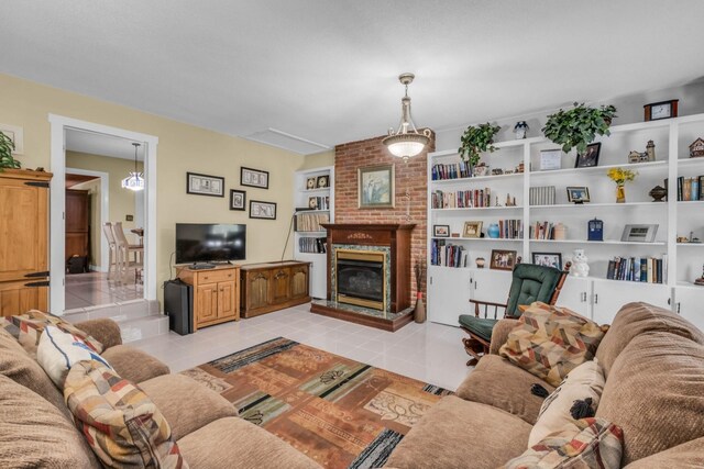 living room with light tile patterned flooring, built in features, and a brick fireplace