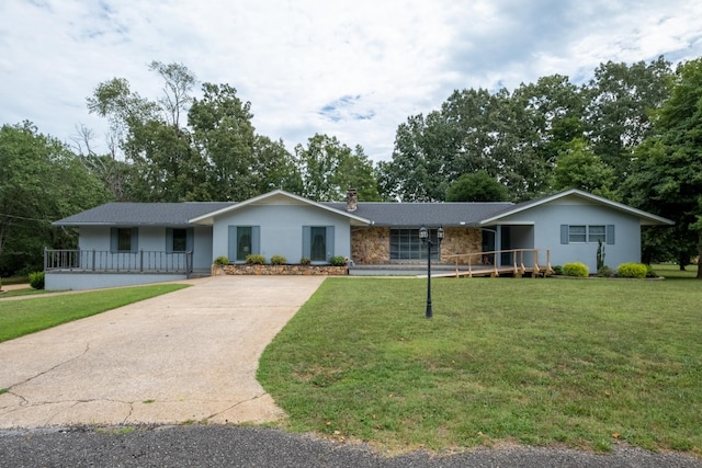 ranch-style house with covered porch and a front lawn