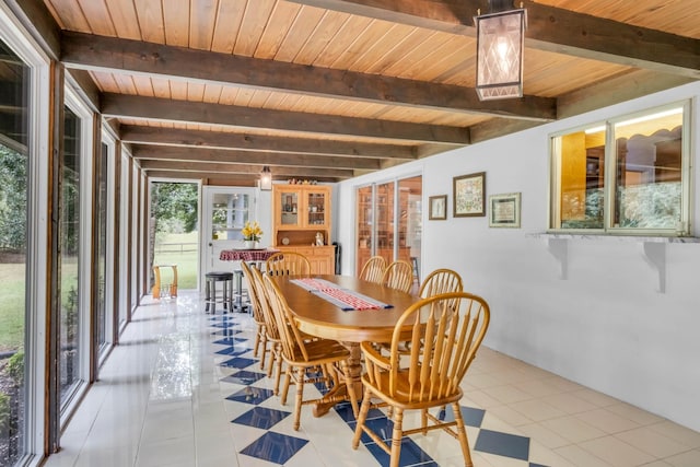 dining room featuring light tile patterned floors, wood ceiling, and beam ceiling