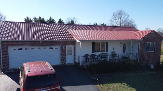 single story home with covered porch and a garage