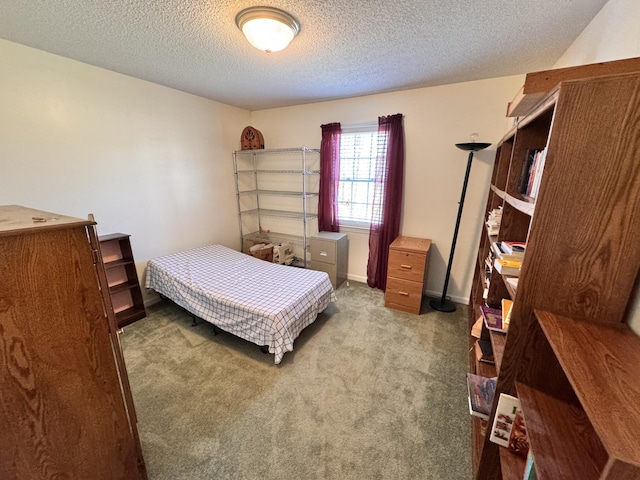 carpeted bedroom featuring a textured ceiling