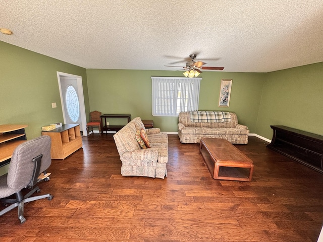 living room with ceiling fan, dark wood-type flooring, and a textured ceiling