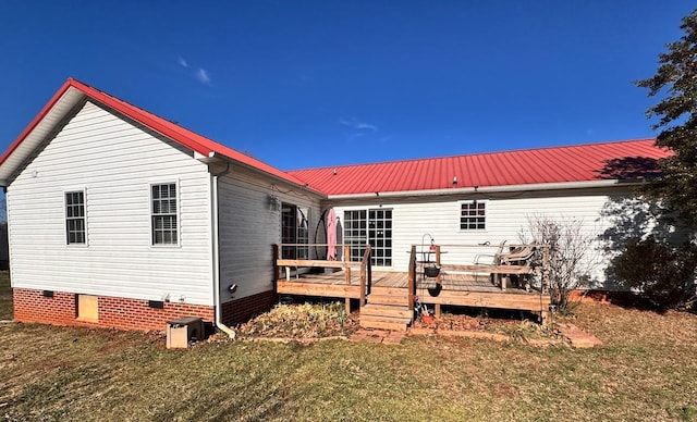 rear view of house featuring a yard and a wooden deck