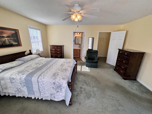 bedroom featuring ensuite bath, ceiling fan, a spacious closet, carpet floors, and a closet