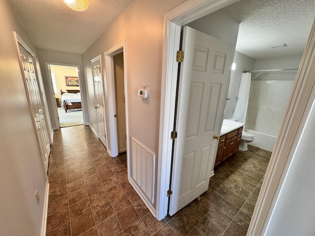 hallway featuring a textured ceiling