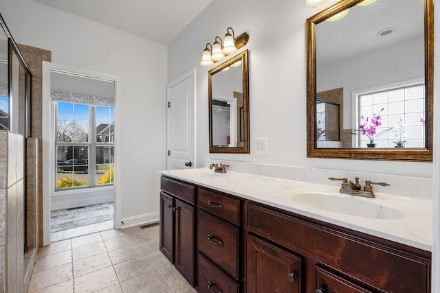 bathroom with tile patterned floors, vanity, and a shower with shower door