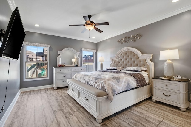 bedroom with light hardwood / wood-style flooring, ceiling fan, and crown molding