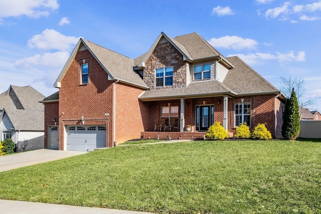 view of front of property with a porch, a garage, and a front lawn