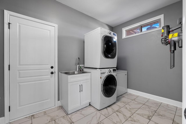 laundry room with cabinets, sink, and stacked washing maching and dryer