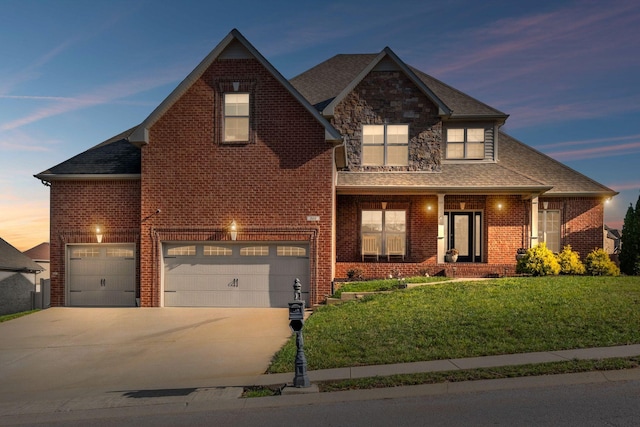 view of front of property with a yard and a garage