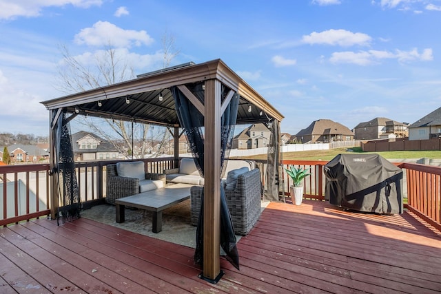 wooden terrace featuring a gazebo and a grill