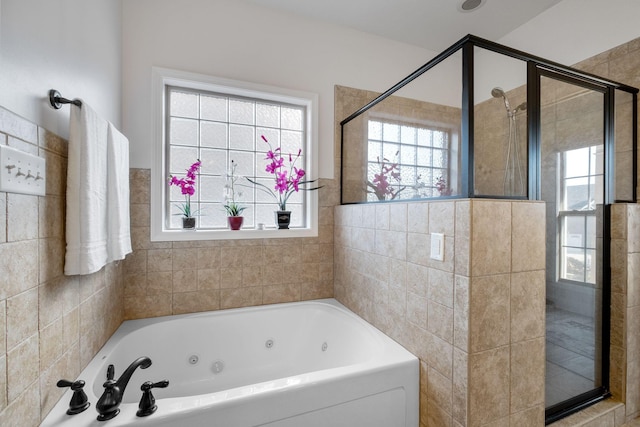 bathroom with a wealth of natural light and independent shower and bath