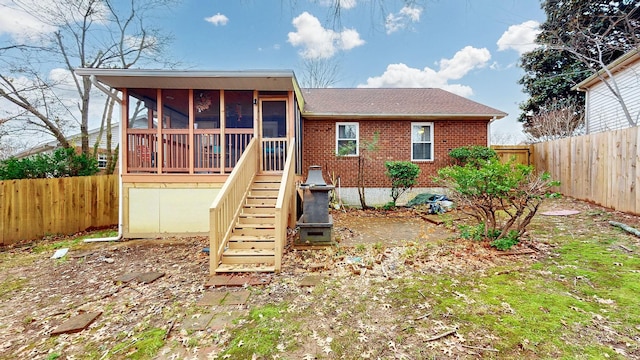 rear view of property with a sunroom