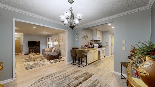 dining area featuring a chandelier, a textured ceiling, light wood-type flooring, and crown molding