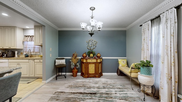 living area featuring a healthy amount of sunlight, ornamental molding, a textured ceiling, and an inviting chandelier