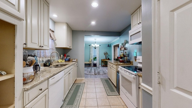 kitchen featuring white cabinetry, sink, decorative light fixtures, white appliances, and light tile patterned floors