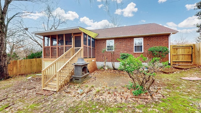 rear view of property with a sunroom