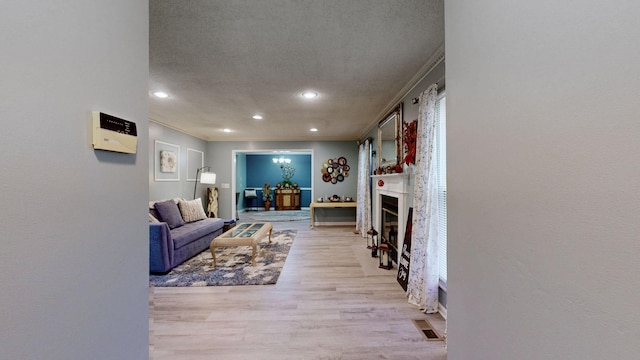 living room with light hardwood / wood-style flooring and ornamental molding