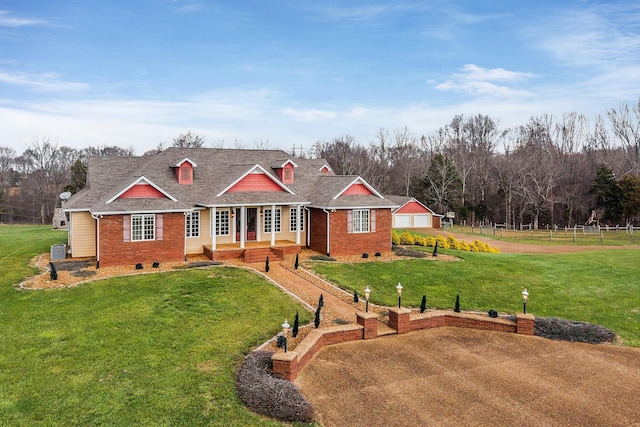 view of front of property with central AC unit and a front lawn