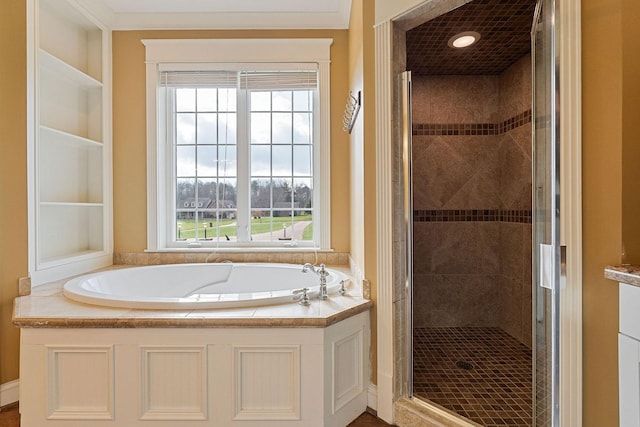 bathroom featuring plenty of natural light, crown molding, and shower with separate bathtub