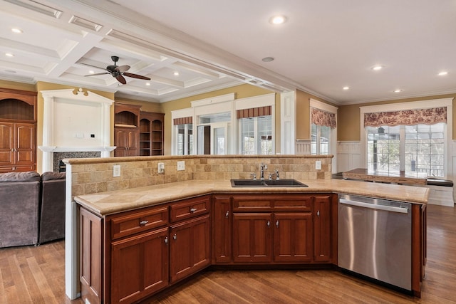 kitchen featuring dishwasher, coffered ceiling, sink, a fireplace, and beam ceiling