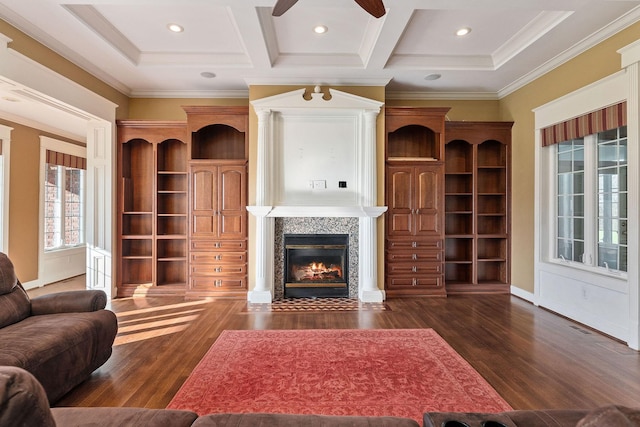 living room featuring ceiling fan, dark hardwood / wood-style flooring, coffered ceiling, and ornamental molding