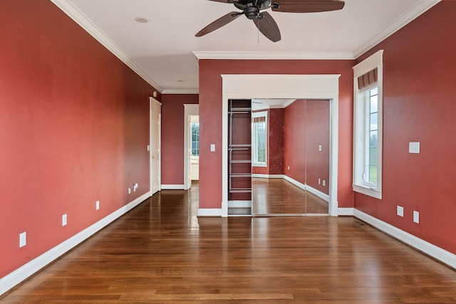 empty room with ceiling fan, dark hardwood / wood-style flooring, and crown molding