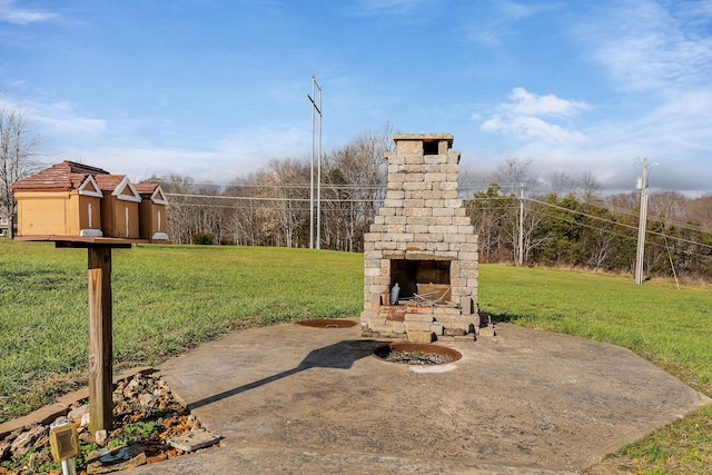 view of patio featuring an outdoor stone fireplace