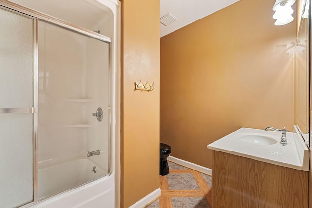 bathroom with vanity and enclosed tub / shower combo