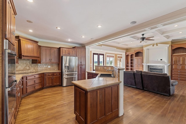 kitchen featuring sink, tasteful backsplash, stainless steel fridge with ice dispenser, light hardwood / wood-style floors, and ornamental molding