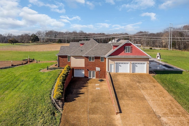 view of front of property featuring a front lawn and a garage