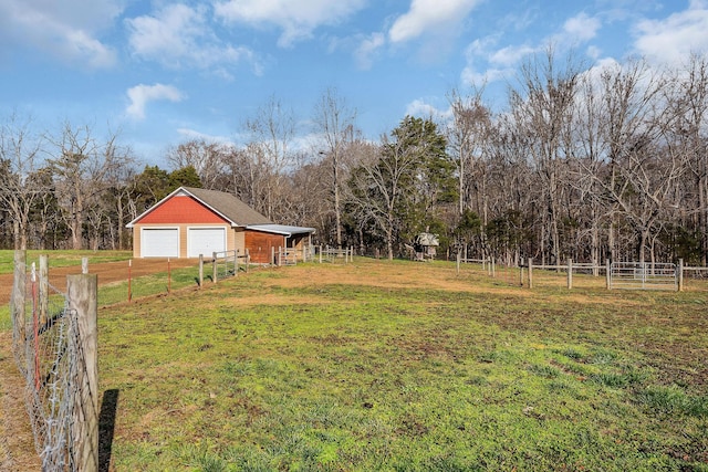 view of yard with a rural view and an outdoor structure