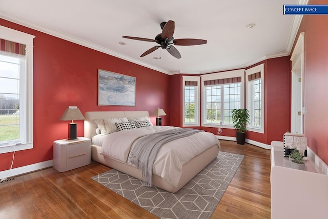 bedroom with ceiling fan, hardwood / wood-style floors, and crown molding