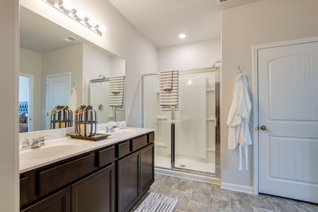 bathroom with vanity and a shower with shower door