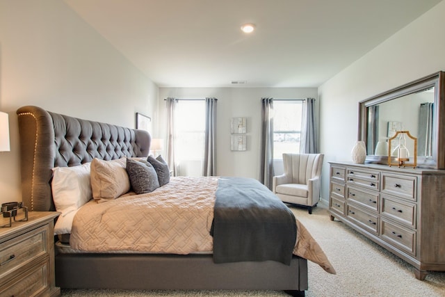 bedroom featuring light carpet