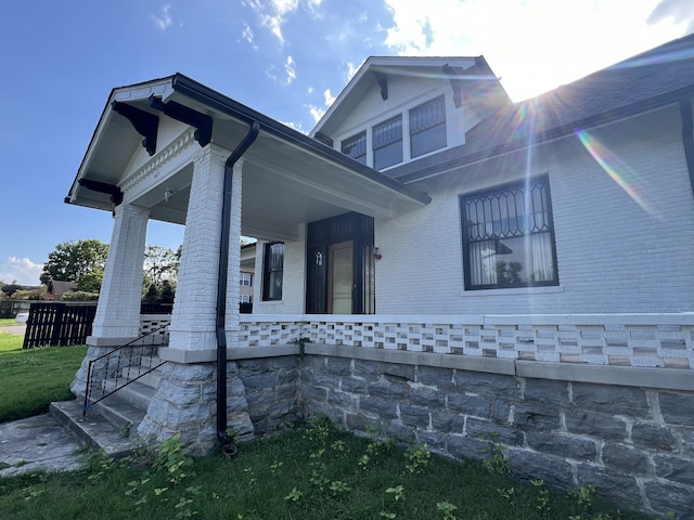 view of side of property featuring a porch