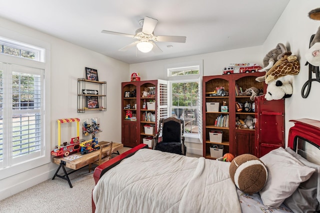 bedroom with carpet flooring, multiple windows, and ceiling fan