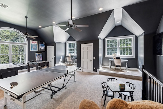 recreation room featuring ceiling fan, light carpet, and vaulted ceiling