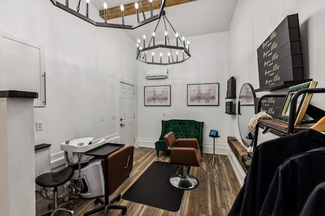 office space featuring a wall mounted air conditioner, wood-type flooring, and a high ceiling